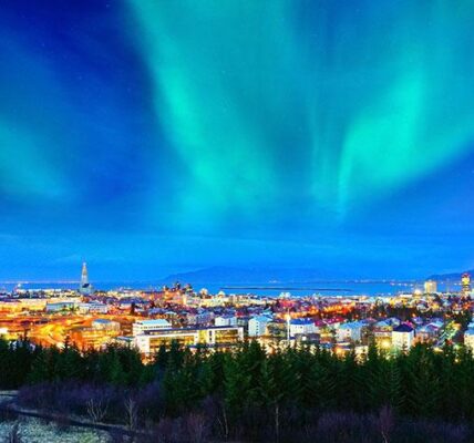 View of the northern light from the city center in Reykjavik, Iceland. ©Javen/stock.adobe.com