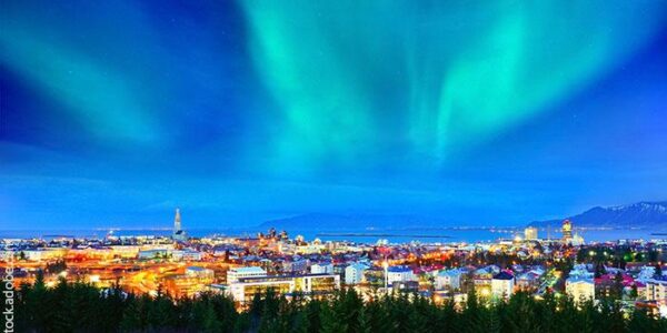 View of the northern light from the city center in Reykjavik, Iceland. ©Javen/stock.adobe.com