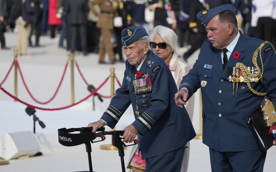 Richard Rohmer, left, one of the most decorated Canadian veterans, is shown at the Government of Canada ceremony to mark the 80th anniversary of D-Day, at Juno Beach, in Courseulles-sur-Mer, Normandy, France, Thursday, June 6, 2024. THE CANADIAN PRESS/Adrian Wyld