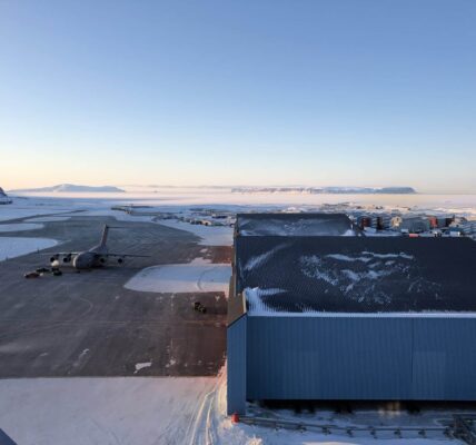 Pituffik Space Base tarmac, hangars, base facilities, and a US C-17 cargo aircraft, set amidst the frozen winter wilderness of Northern Greenland. Photo: David Palmer