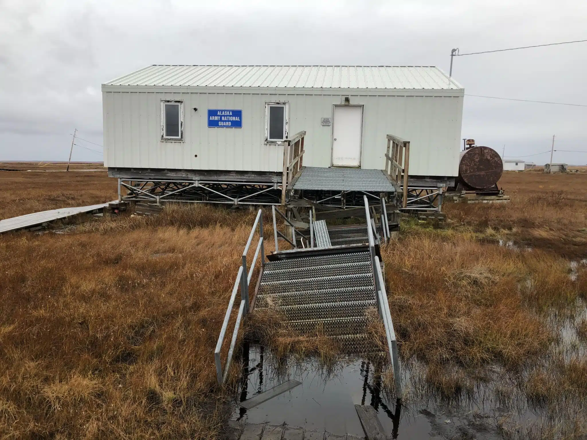 An abandoned federal building sinks into the thawing permafrost in the Native Village of Nunapicuaq (Nunapitchuk), Alaska. Photo: Susan Natali