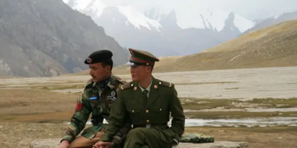 Chinese and Pakistani border guards clasp hands at the Karakoram Highway’s Khunjerab Pass, the highest paved international border crossing globally. Photo: Anthony Maw
