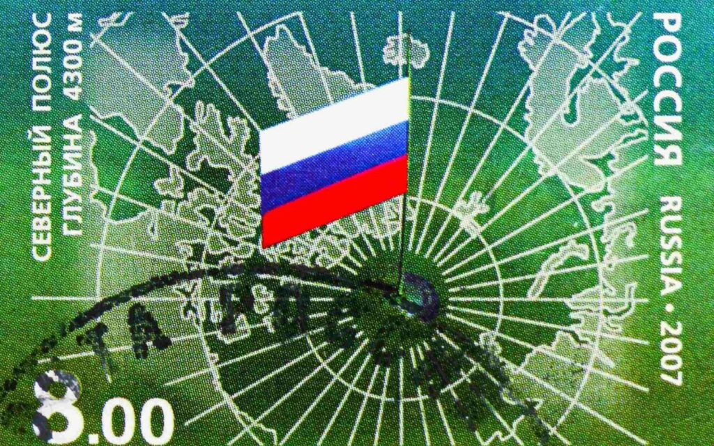Postage stamp printed in Russia shows a mirrored map of the Arctic, with Russian flag on the North Pole. Credit: Alexander Mitrofanov