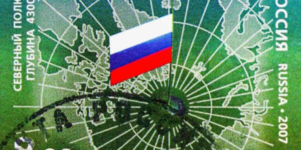 Postage stamp printed in Russia shows a mirrored map of the Arctic, with Russian flag on the North Pole. Credit: Alexander Mitrofanov