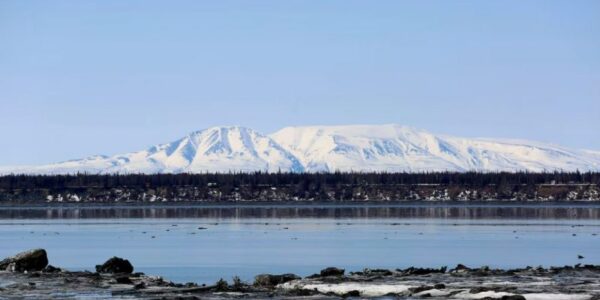 Mount Susitna is shown Friday, April 16, 2021, on the other side of Cook Inlet from downtown Anchorage, Alaska. No oil companies filed bids to drill in more than 400,000 hectares of Cook Inlet before the deadline Wednesday. (Mark Thiessen/AP)