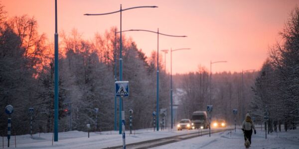 A woman walks her dog in Ivalo, Finnish Lapland. Maintaining 24-hour emergency care here was among the measures decided on Monday. (Jonathan Nackstrand/AFP via Getty Images)